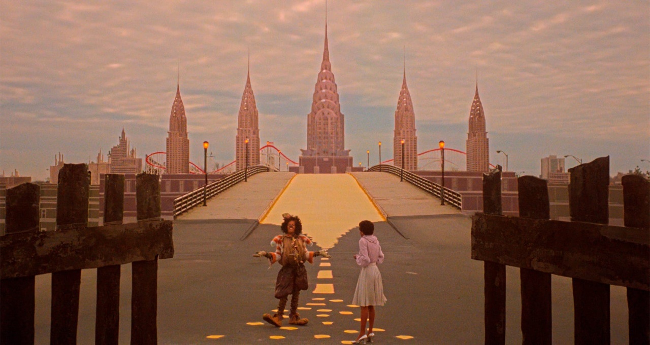 Two people walk on a yellow brick road toward an art deco city skyline under a cloudy sky, framed by a gated entrance in the foreground.