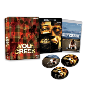 Box set of "Wolf Creek" featuring a plaid-patterned case, two Blu-ray covers, and three discs arranged on a black background.