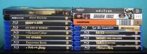 No Streaming Required: Physical Media Spotlight For The Week Of July 8th – Exploring The Warner Archive Stacks of Blu-ray and Ultra HD movie cases are arranged side by side against a blue background, showing various film titles on their spines.