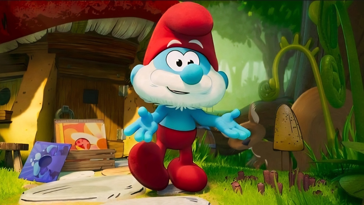A blue cartoon character with a red hat and pants stands outside a wooden cottage, holding out its arms, surrounded by greenery and colorful objects.