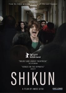 A woman stands screaming in a crowded hallway while people look on; text shows the film’s title “Shikun” and credits, with festival and review mentions.