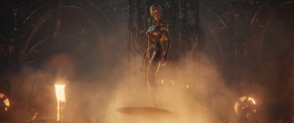 A metallic humanoid figure stands on a circular platform surrounded by steam and industrial machinery in a dimly lit, futuristic setting.