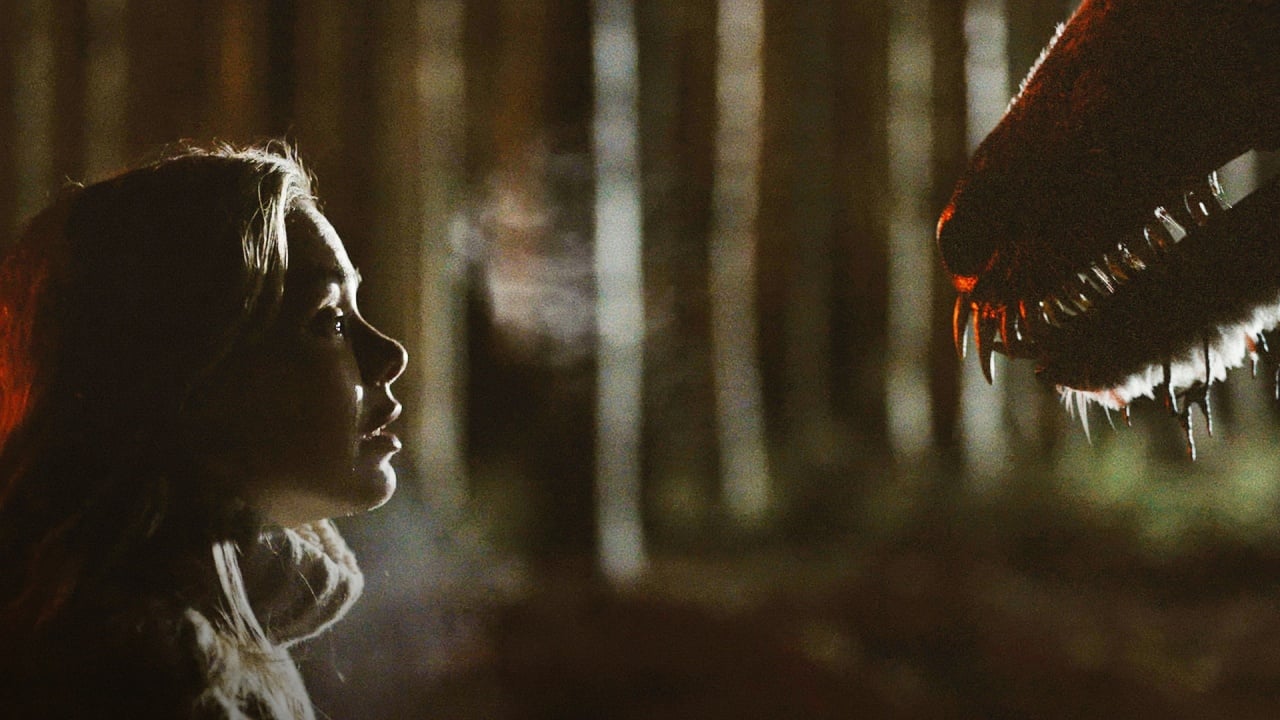 A person stands face-to-face with a large creature showing sharp teeth in a dimly lit forest at night.