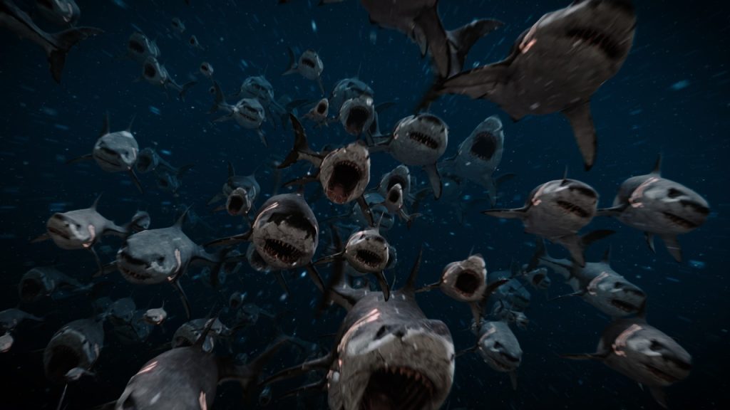 A large group of sharks with open mouths swims toward the viewer in dark, deep ocean water.