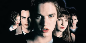 Five young adults with serious expressions stand closely together against a dark background.