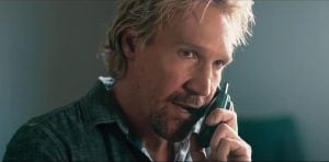 Sony Pictures Home Entertainment Debuts Clip For Action-Packed Thriller ‘A Line Of Fire’ To Celebrate Digital Release (EXCLUSIVE) A man with blond hair and a beard holds a phone to his ear, speaking seriously indoors.