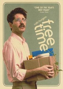 A man with glasses and a mustache holds a box with office items and a plant. The text reads “free time” and “one of the year’s best films.”.