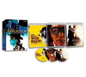 A box set of three John Huston films on Blu-ray and DVD: "Wise Blood," "Under the Volcano," and "The Dead," with corresponding discs and illustrated slipcovers.