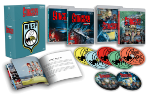 Box set display of the TV series "Stingray," including Blu-ray cases, DVDs, a booklet, and collectible art cards, all arranged on a black background.
