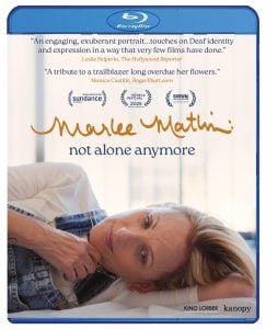 Blu-ray cover of "Marlee Matlin: Not Alone Anymore," showing Marlee Matlin lying down and smiling, with review quotes and festival logos above the title.