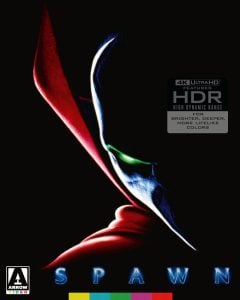 Close-up of Spawn’s masked face shrouded in shadow, with a glowing green eye, prominent red cape, and logos for Arrow Video and 4K Ultra HD on a black background.