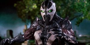 Arrow Video’s October Slate Include 4K UHD & Blu-Ray Releases From John Carpenter, Abel Ferrara & More A character in a black and white armored suit with glowing green eyes stands outdoors at night, with trees and a misty background visible.