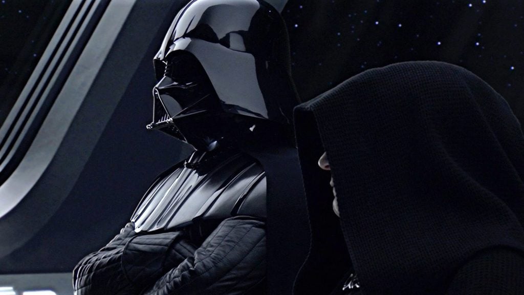 Darth Vader and Emperor Palpatine stand together on a spaceship with a star-filled window in the background.