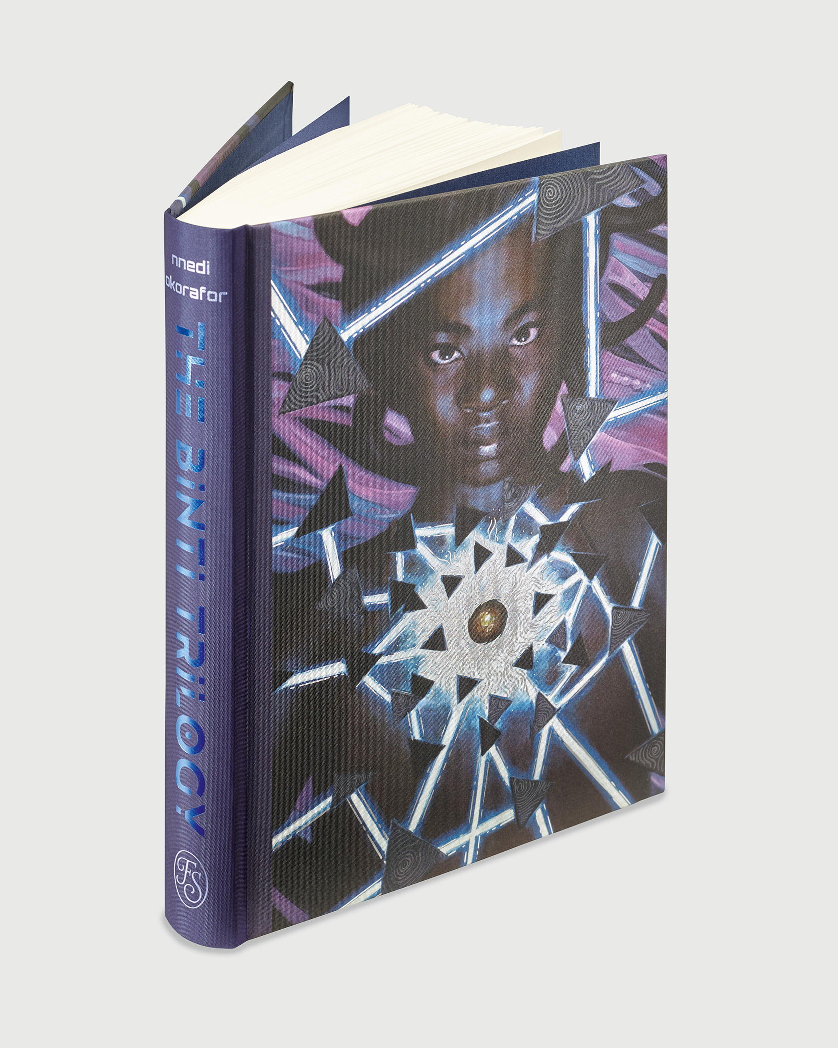 A hardcover book titled "The Binti Trilogy" by Nnedi Okorafor, featuring a geometric, futuristic cover design with a portrait of a person.