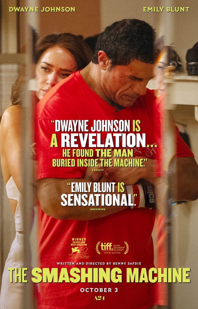 Dwayne Johnson and Emily Blunt stand closely together in a room; promotional text and review quotes for the film "The Smashing Machine" overlay the image.