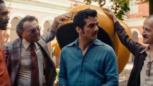 Criterion Collection Announces September Titles Including Works From Sidney Lumet, Richard Linklater & More Four men stand together outside, with one man in a blue shirt in the center and a large yellow object behind them.