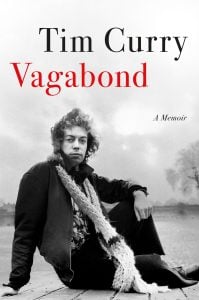 Black-and-white photo of a young man sitting outdoors in a jacket and scarf. Text reads: "Tim Curry Vagabond A Memoir.