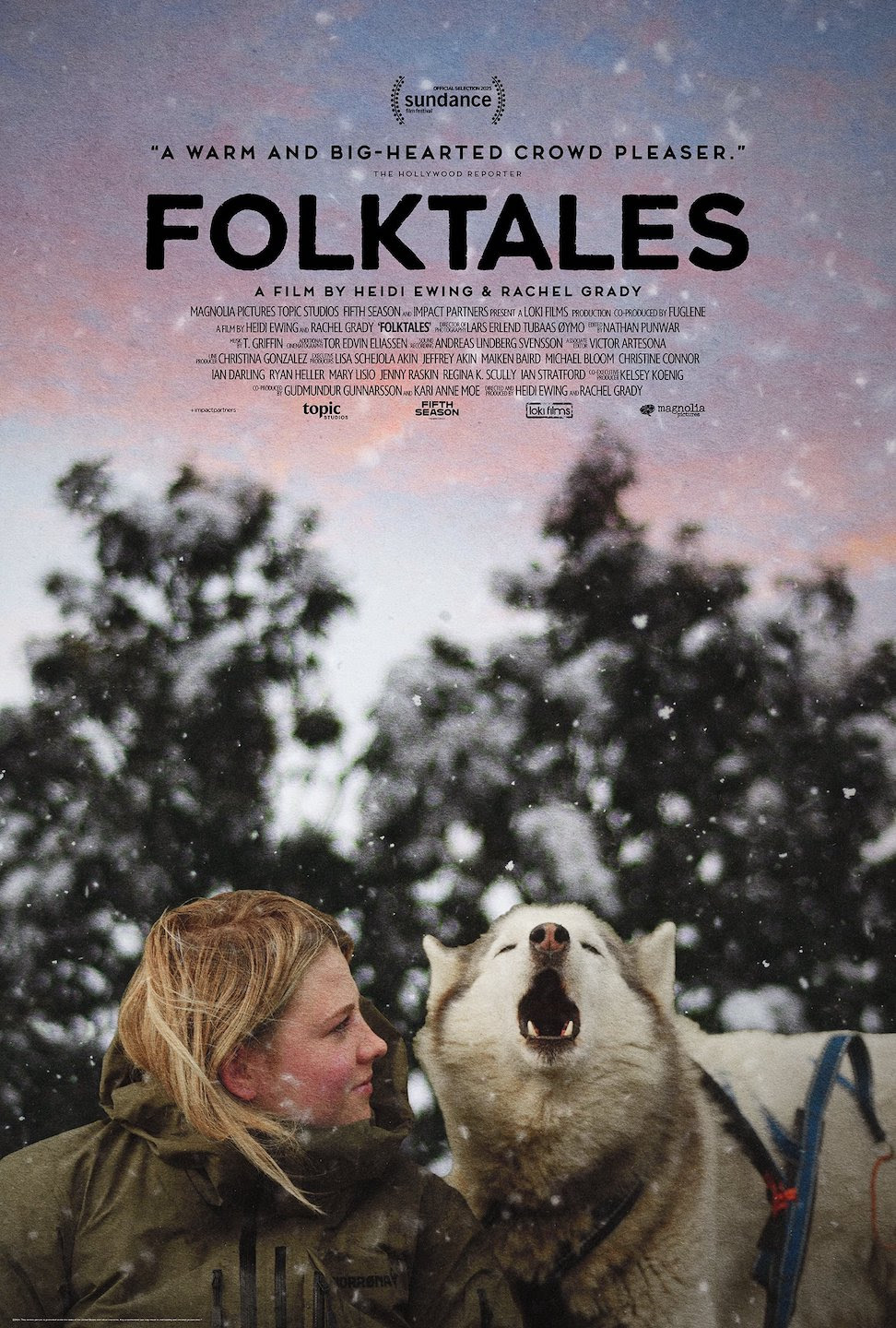 A person in a winter coat stands beside a howling dog in falling snow, with the title "Folktales" and film credits above them.