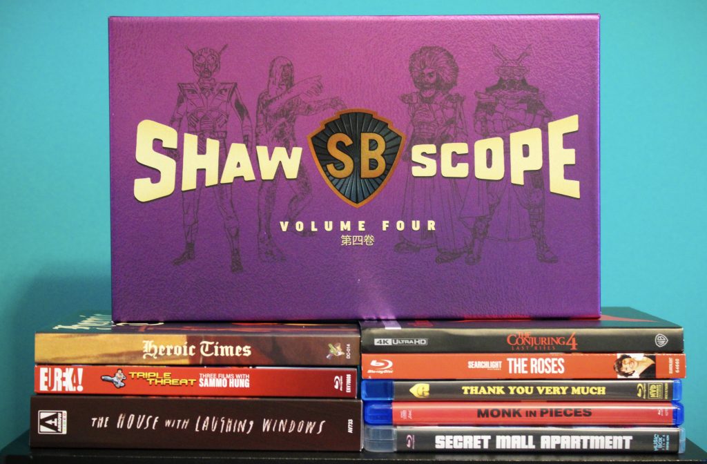 A box set labeled "Shaw Scope Volume Four" is displayed above a stack of eight DVD and Blu-ray movie cases against a teal background.