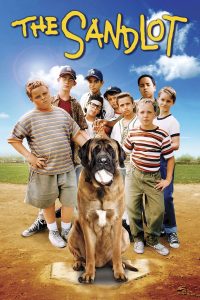 A group of boys stands on a baseball field with a large dog holding a baseball in its mouth; "The Sandlot" title appears above them.