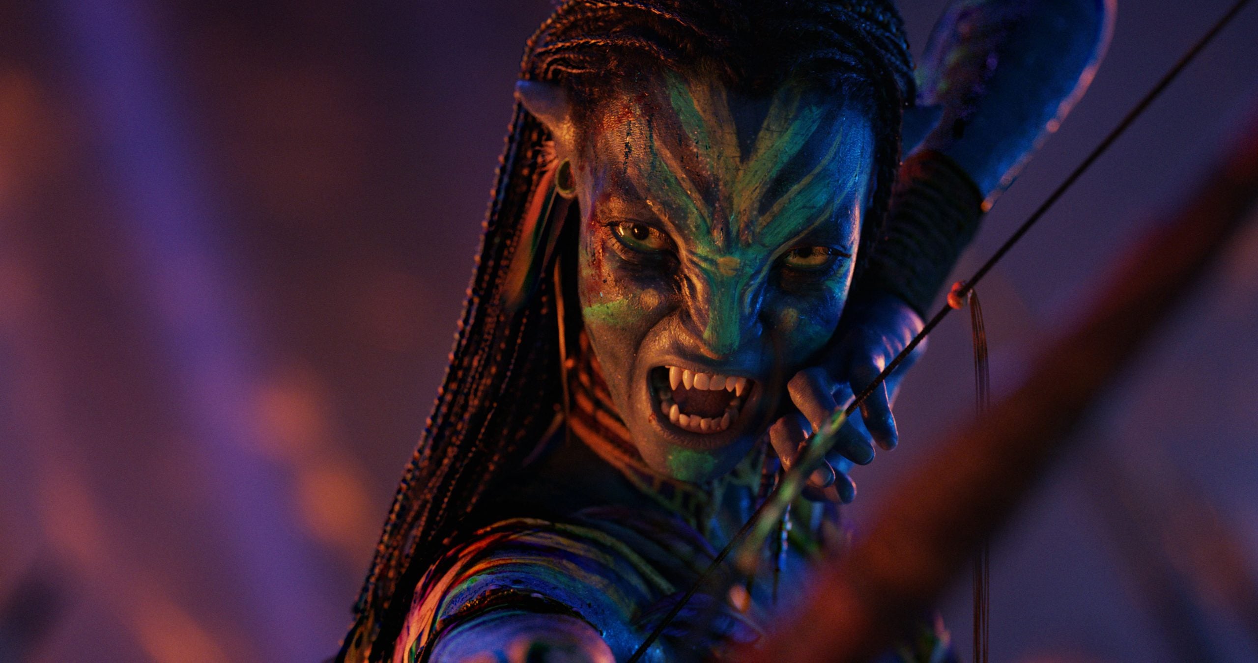 A blue-skinned humanoid with braided hair, pointed ears, and glowing stripes draws a bow, baring fangs and aiming an arrow in a dramatic, colorful setting.