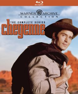 A man in a cowboy hat and western attire stands in front of a desert landscape on the cover of the "Cheyenne: The Complete Series" Blu-ray from Warner Archive Collection.