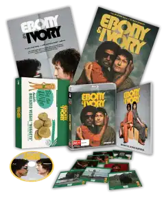 A box set for the film "Ebony & Ivory," featuring posters, a DVD, disc, photos, and a package of breaded veggie nuggets, arranged against a black background.