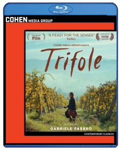 Blu-ray cover for the film "Trifole" shows a woman walking through a vineyard with hills in the background, presented by Cohen Media Group.