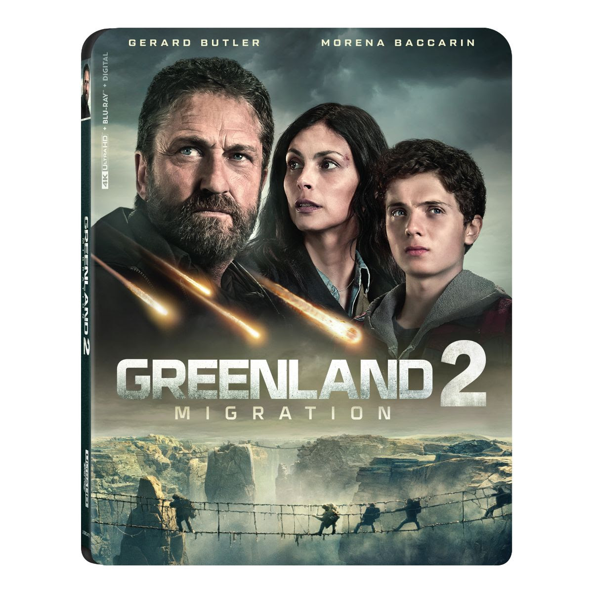 The cover of "Greenland 2: Migration" shows three people looking ahead with meteors falling in the sky and a rope bridge over a canyon below them.