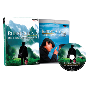 A Blu-ray set of "Riding Alone for Thousands of Miles" is displayed with a case, disc, and cover art featuring a man in a hat walking toward mountains.