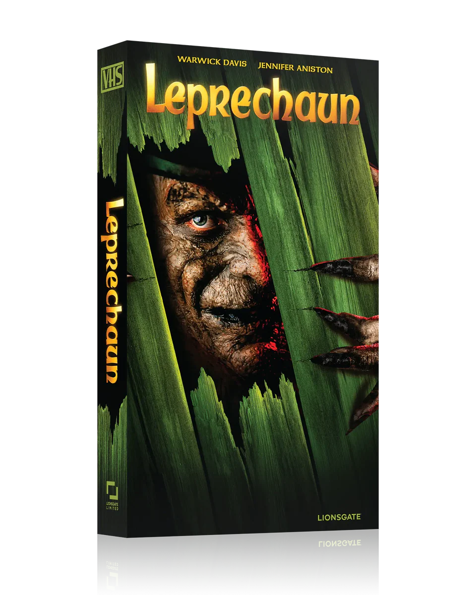 A VHS tape of the movie "Leprechaun" featuring a menacing face and clawed hand breaking through wooden planks on the cover.
