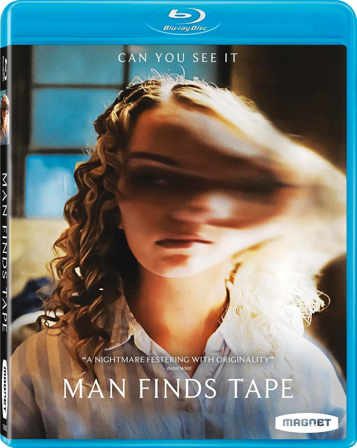 Blu-ray cover for "Man Finds Tape" shows a woman with a blurred, distorted face in a dimly lit setting. The text reads "Can You See It" and includes a review quote and the title.