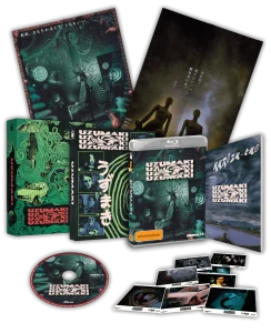 A collector's edition box set of "Uzumaki" with Blu-ray case, disc, booklet, art cards, postcards, and two posters featuring spiral-themed and atmospheric horror artwork.