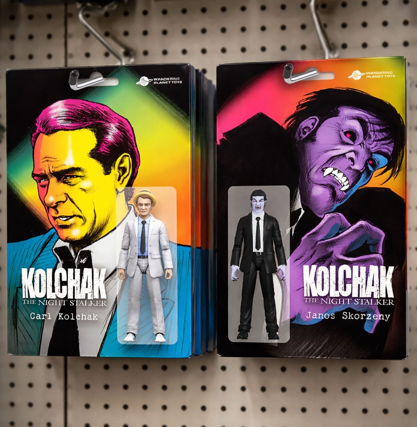 Two action figures in packaging displayed on hooks: one of Carl Kolchak with a colorful background, and one of Janos Skorzeny with a purple, monstrous depiction.