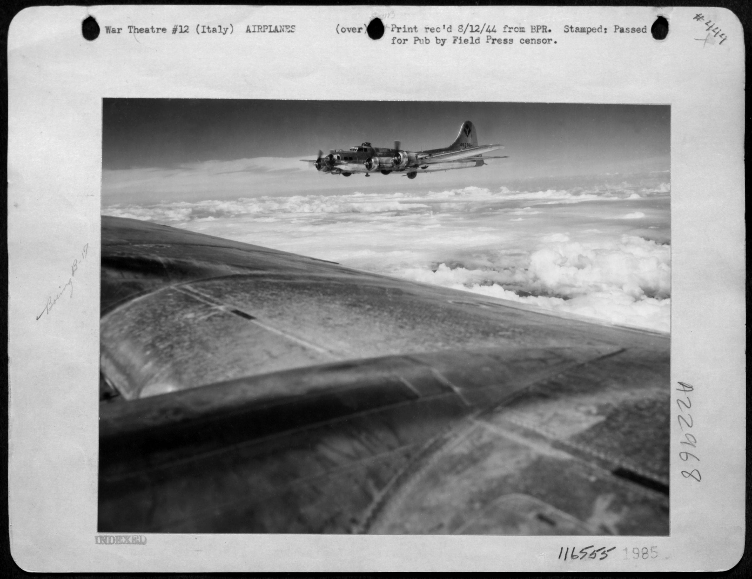 A B-17 bomber flies above the clouds over Italy during World War II, photographed from another aircraft in flight.