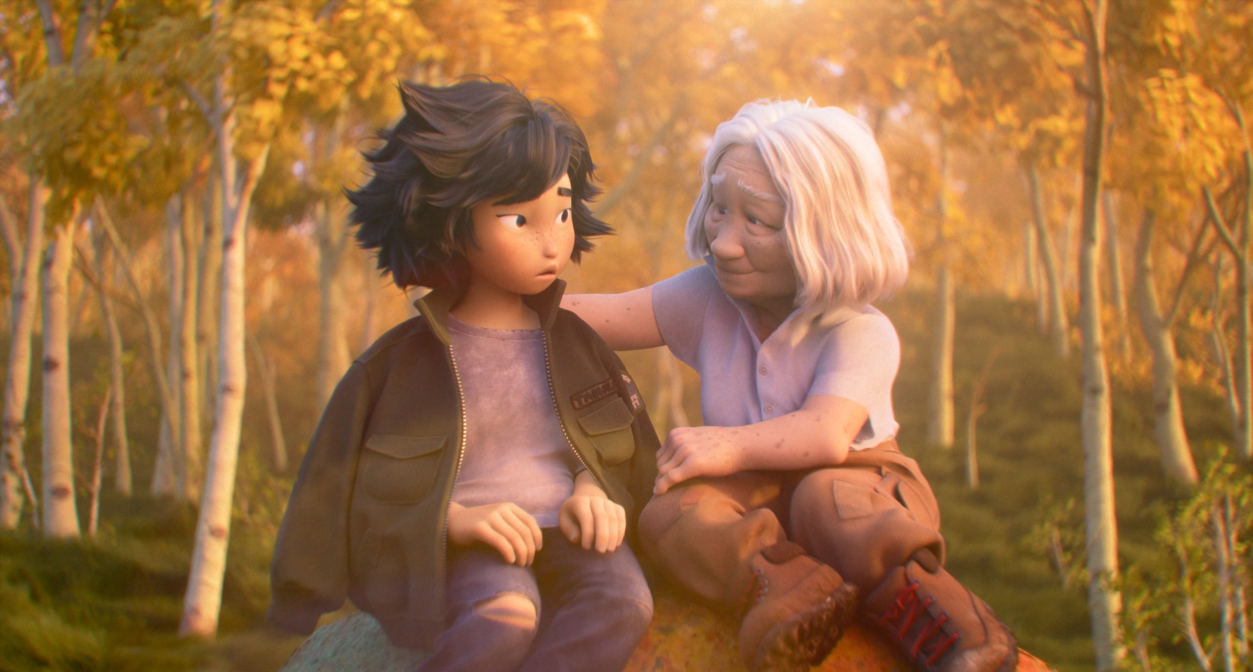 Two animated characters sit on a rock in a forest with autumn foliage; one, an elderly woman, comforts a younger person by placing a hand on their shoulder.