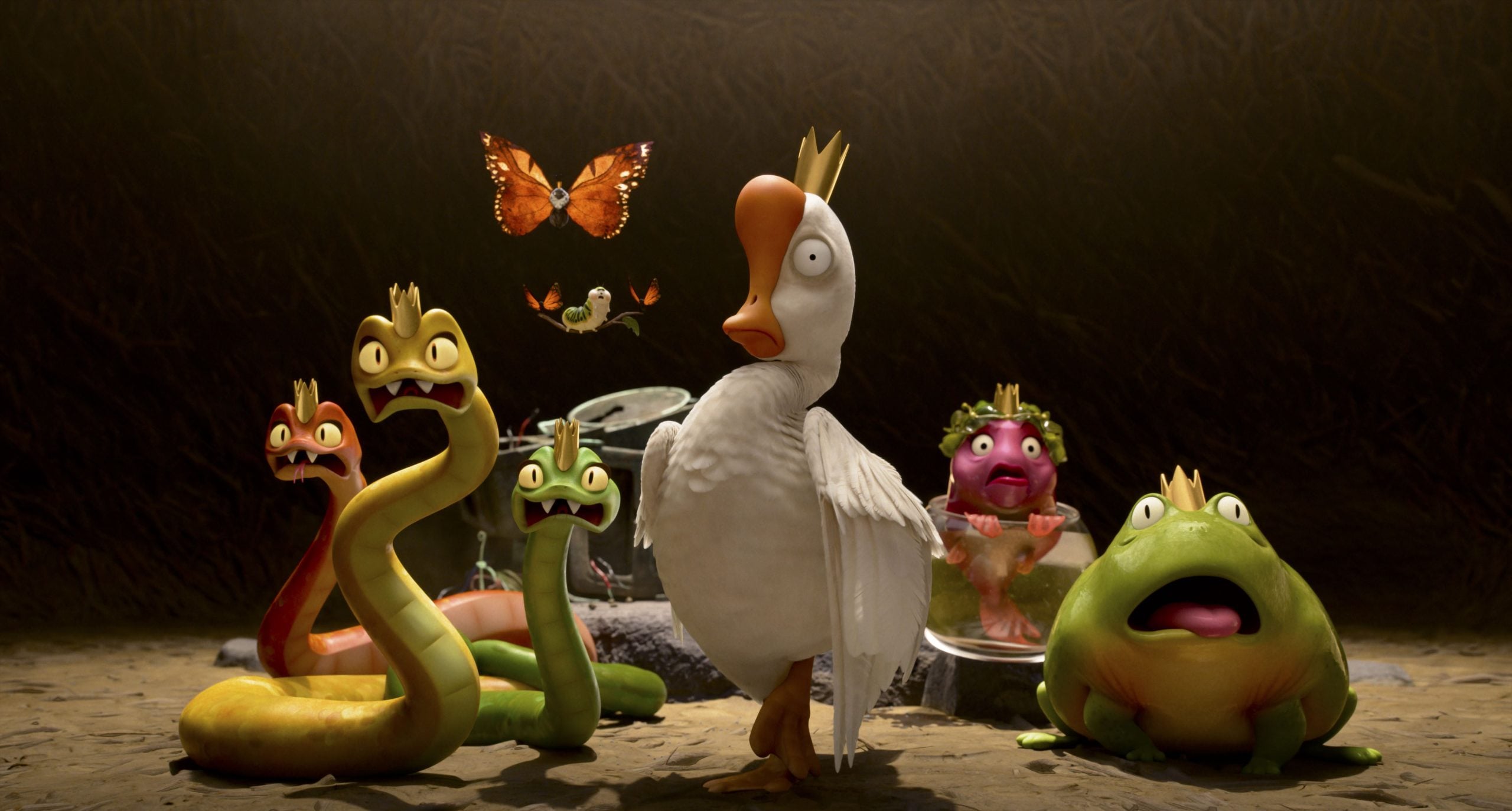 A white duck wearing a crown stands surrounded by animated snakes, frogs, and a butterfly, all with expressive faces, against a dark background.