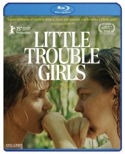 Blu-ray cover of "Little Trouble Girls" showing two young women facing each other closely in a natural, outdoor setting. Title and film festival awards are visible on the cover.