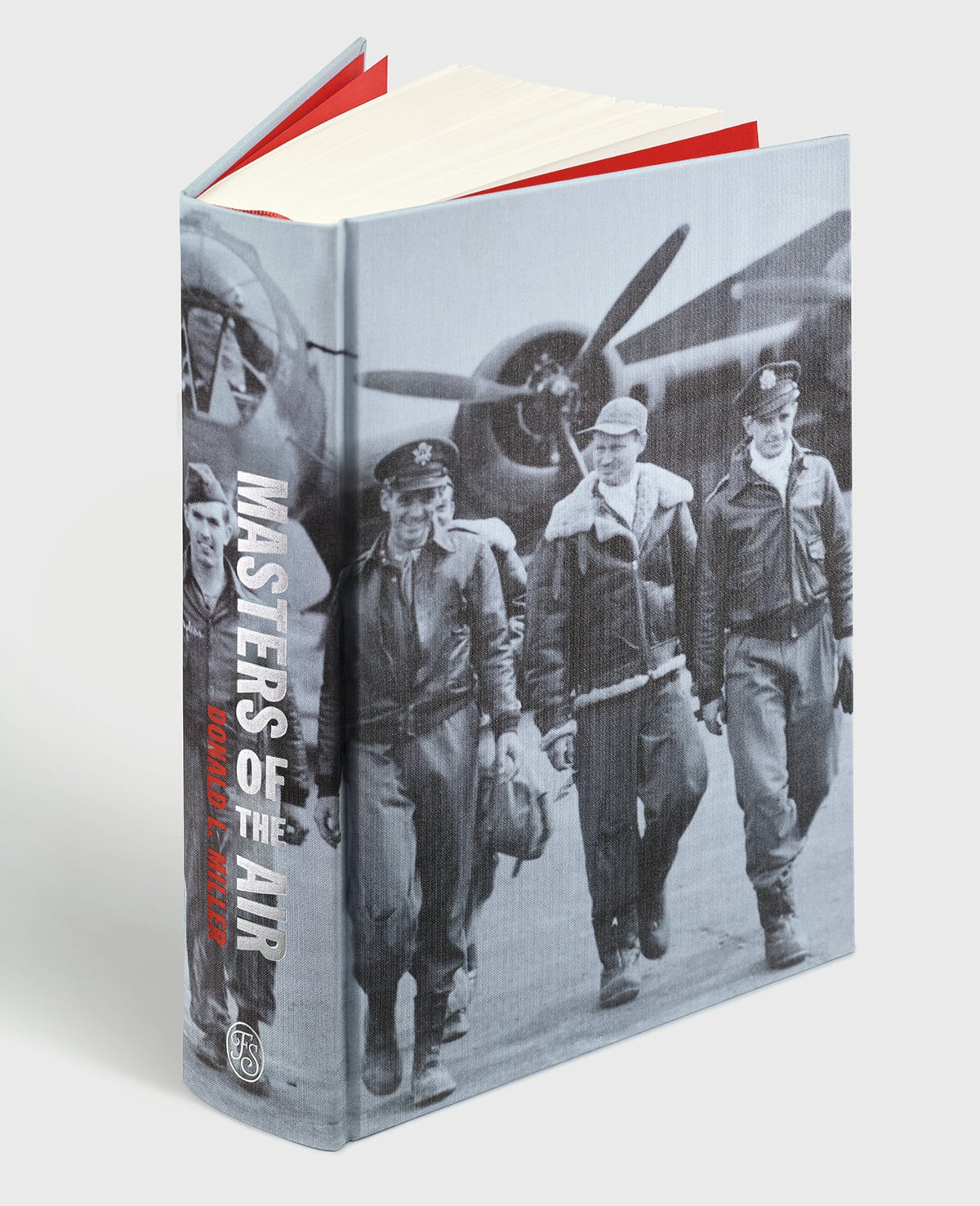 A hardcover book titled "Masters of the Air" by Donald L. Miller features a black-and-white photo of four WWII airmen walking in front of a bomber aircraft.