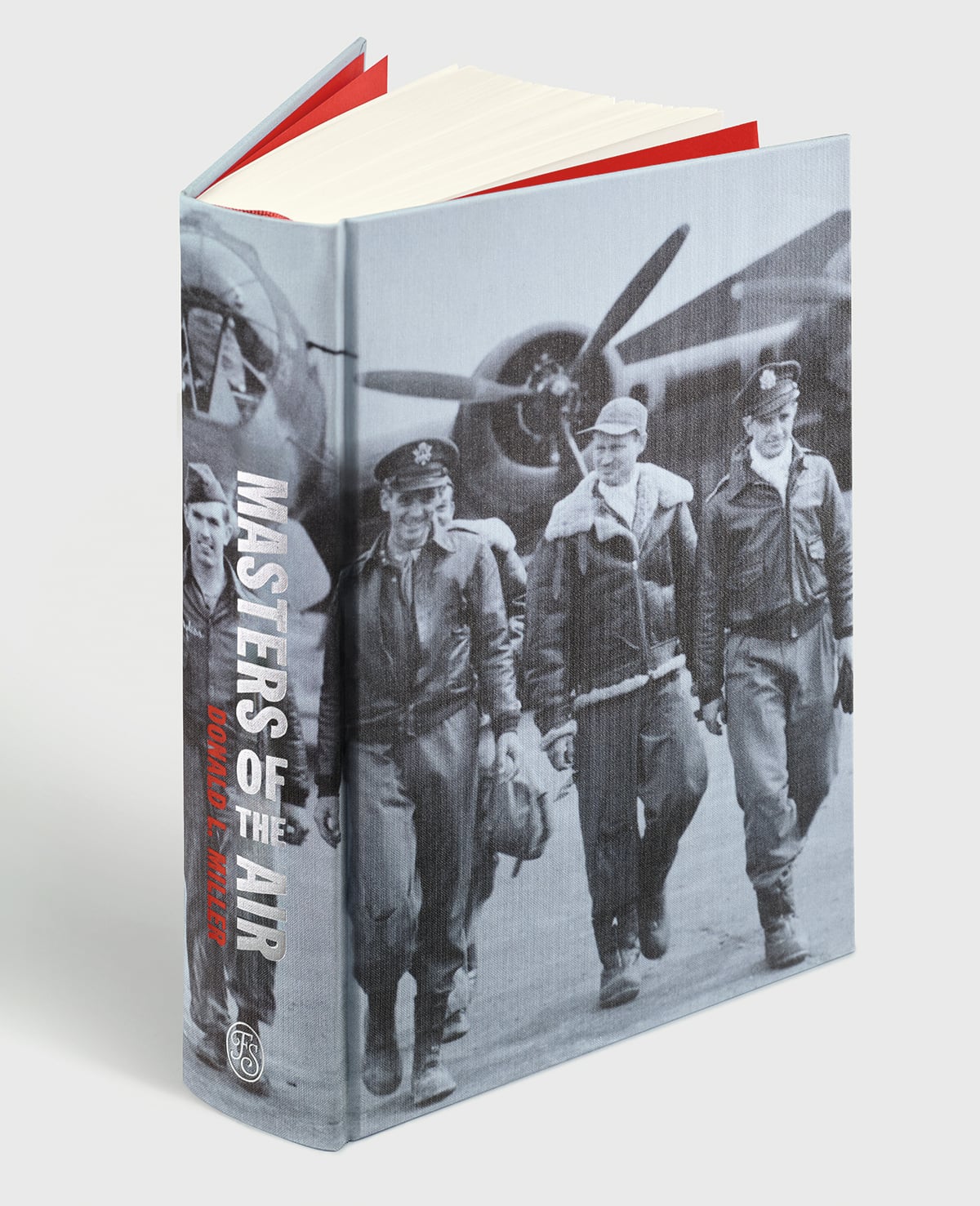 A hardcover book titled "Masters of the Air" features a black-and-white photo of World War II pilots walking in front of a bomber aircraft.