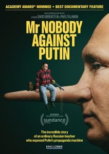 Movie poster for "Mr. Nobody Against Putin" showing a man sitting on an extended nose, with another man’s face in profile; includes award and tagline text.