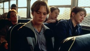 Warner Bros. To Release The Star-Studded Thriller ‘Sleepers’ On 4K UHD Blu-Ray For 30th Anniversary Four teenagers sit on a school bus, looking pensive and distant, with sunlight coming through the bus windows.