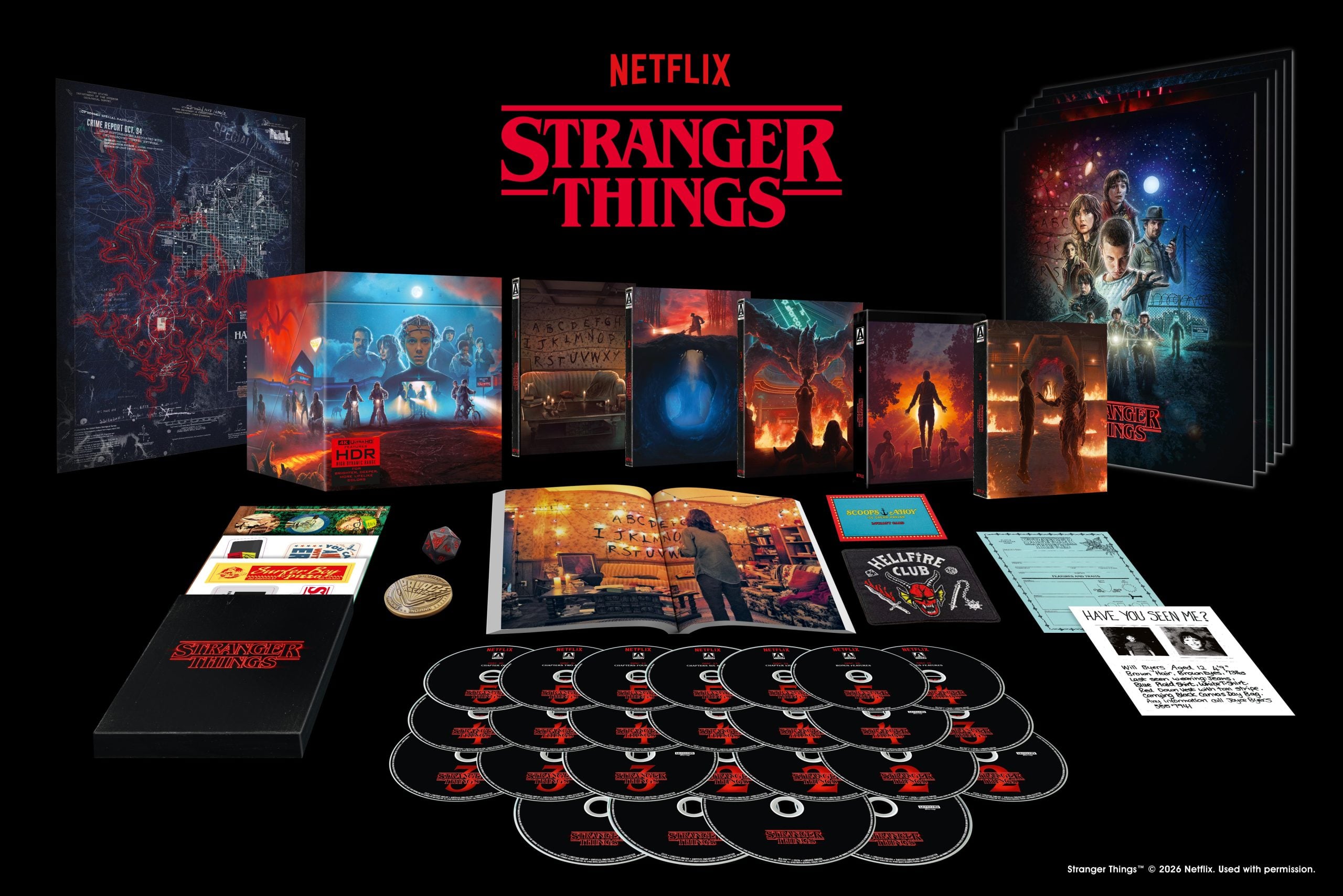 A Stranger Things Blu-ray collector’s set with multiple discs, artwork, posters, booklets, cards, and memorabilia displayed on a black surface, featuring the Netflix logo.