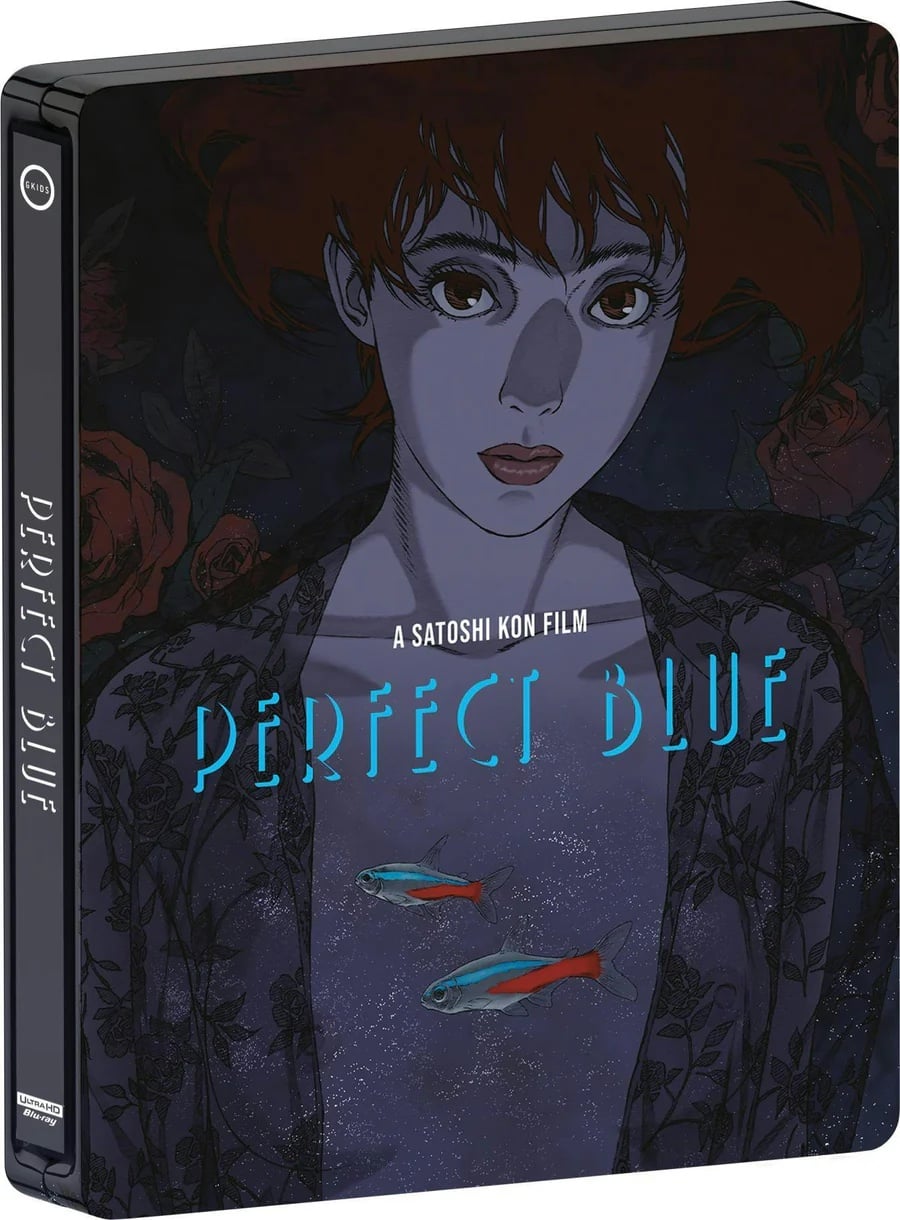 Blu-ray cover of "Perfect Blue," an animated film by Satoshi Kon, featuring an illustrated woman with red hair, floral patterns, and two small fish in front of her.