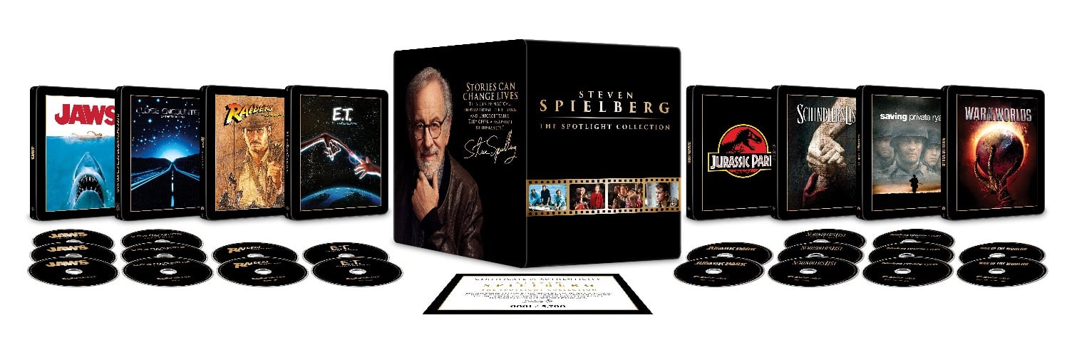 Box set of Steven Spielberg films with DVD cases and discs for movies including Jaws, E.T., Jurassic Park, and Saving Private Ryan, arranged in a row with a collector’s certificate.