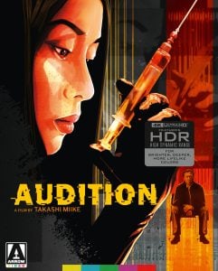 A stylized illustration of a woman holding a large syringe dominates the cover for the film "Audition" by Takashi Miike, with a smaller image of a seated man at the bottom.