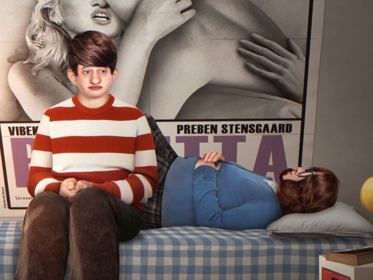 A boy in a red and white striped sweater sits on a plaid bed next to a person lying down, with a large black-and-white movie poster in the background.