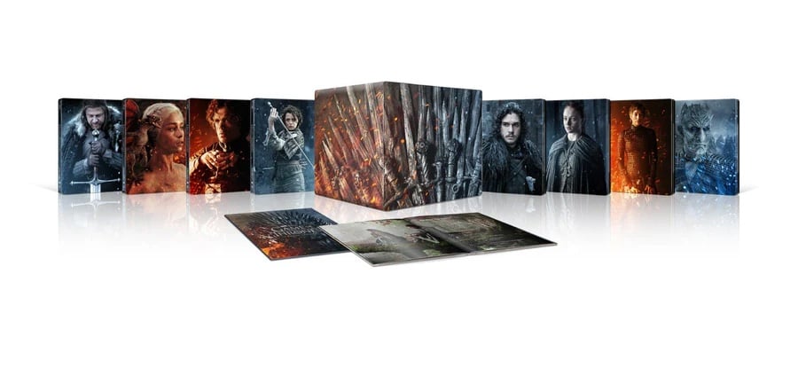 A box set of Game of Thrones Blu-ray discs is displayed, featuring character artwork and two open booklets in front of the case.