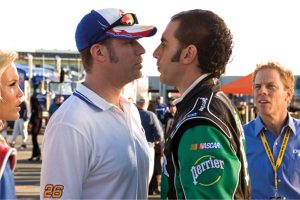 Sony To Release ‘Talladega Nights: The Ballad Of Ricky Bobby’ On 4K UHD Blu-Ray This August Two men stand face-to-face in a tense confrontation at a racetrack, surrounded by onlookers and racing team members.