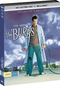 Blu-ray box of "The 'Burbs" Collector’s Edition featuring Tom Hanks in pajamas with a spatula, standing in a suburban neighborhood with stormy skies.